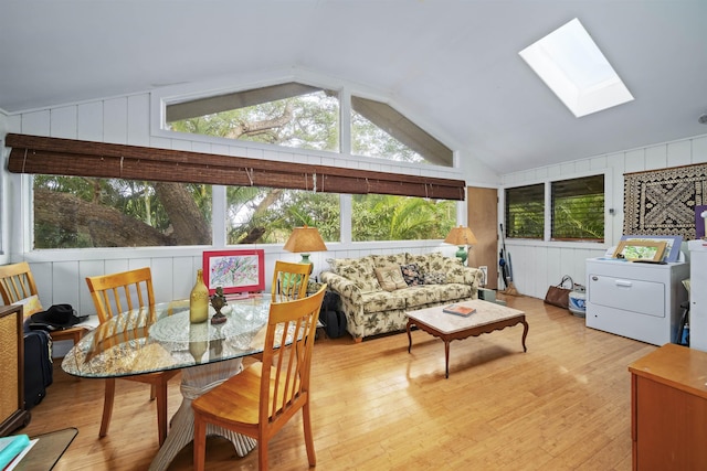 sunroom featuring washer / clothes dryer and vaulted ceiling with skylight