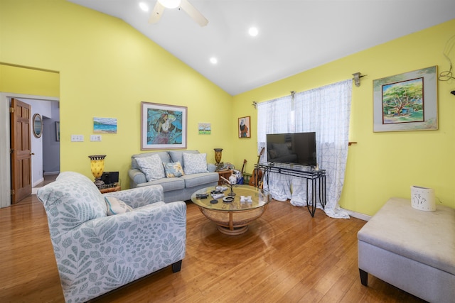 living room featuring ceiling fan, wood-type flooring, and high vaulted ceiling