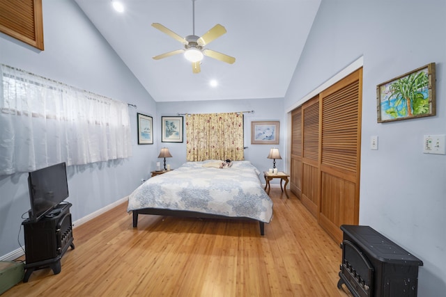 bedroom featuring ceiling fan, high vaulted ceiling, light hardwood / wood-style floors, and a closet