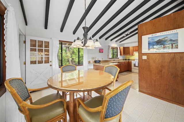 dining room with vaulted ceiling with beams, sink, and an inviting chandelier