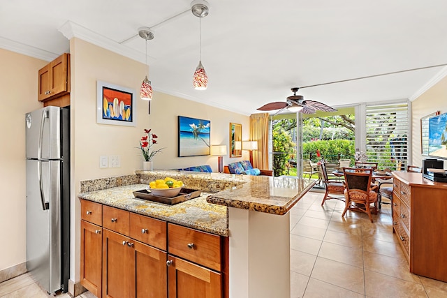 kitchen with ceiling fan, kitchen peninsula, stainless steel fridge, crown molding, and decorative light fixtures