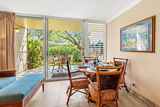 tiled dining space with crown molding and expansive windows