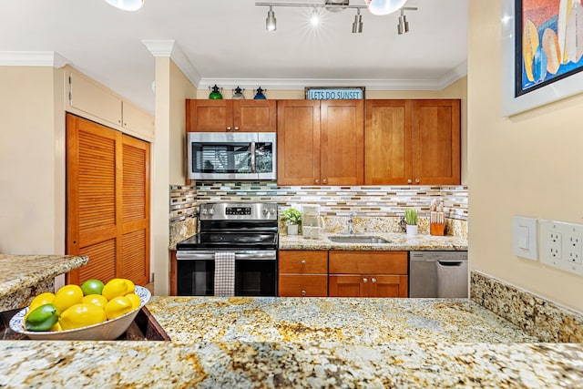 kitchen featuring crown molding, sink, appliances with stainless steel finishes, and tasteful backsplash