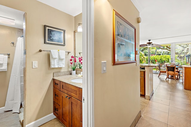 bathroom with tile patterned flooring, vanity, and ceiling fan