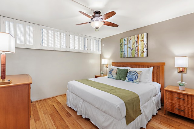 bedroom with light hardwood / wood-style floors and ceiling fan