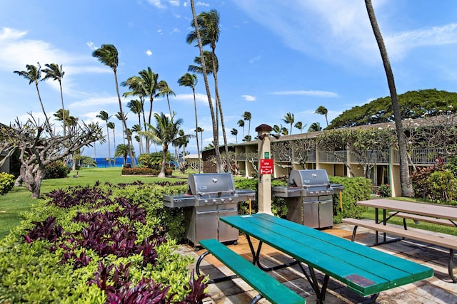 view of patio / terrace featuring a water view and a grill