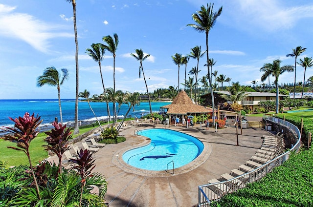 view of pool with a gazebo, a water view, and a patio area