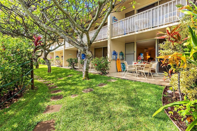 view of yard with a patio area and a balcony