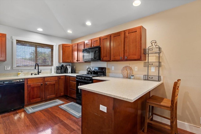 19 Heona Pl, Kihei, HI 96753 - kitchen featuring black appliances, a peninsula, dark wood finished floors, light countertops, and recessed lighting