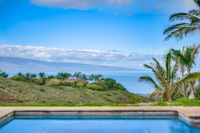 view of swimming pool with a water view