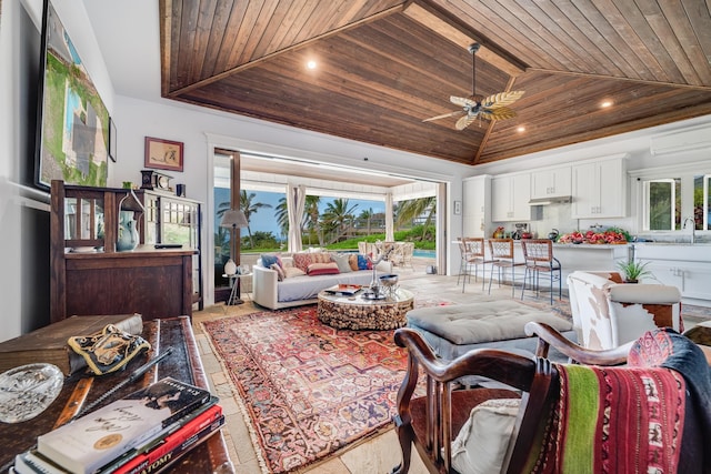 living room with wood ceiling, high vaulted ceiling, ceiling fan, and sink