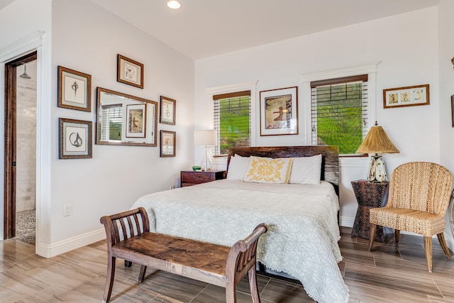 bedroom featuring hardwood / wood-style floors and connected bathroom