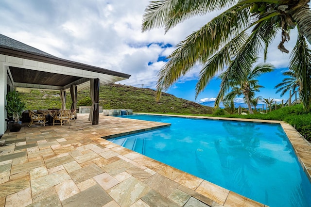 view of swimming pool with a gazebo and a patio area