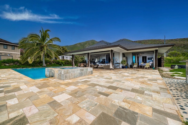 view of swimming pool with a patio, an outdoor hangout area, and an in ground hot tub