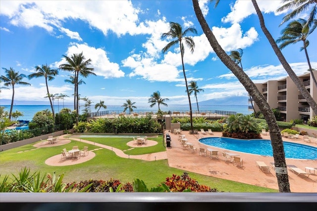 view of swimming pool with a patio area and a water and mountain view