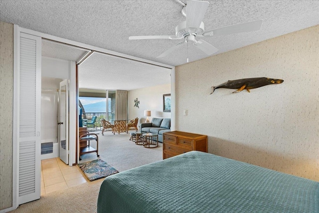 tiled bedroom with ceiling fan and access to outside