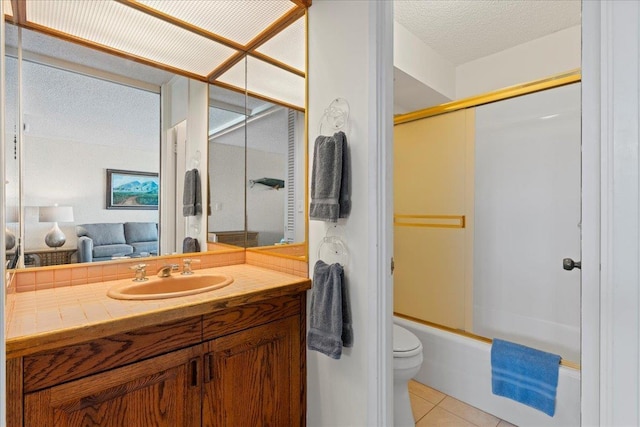 full bathroom featuring a textured ceiling, tile patterned floors, vanity, toilet, and combined bath / shower with glass door