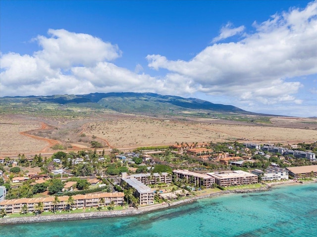 birds eye view of property with a view of the beach and a water and mountain view