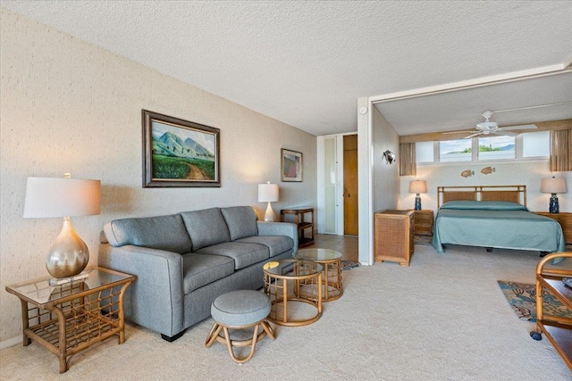 carpeted living room featuring ceiling fan and a textured ceiling