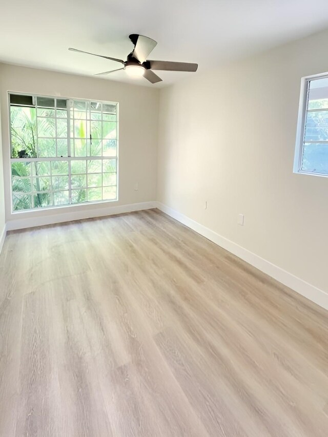 unfurnished room featuring ceiling fan and light hardwood / wood-style floors