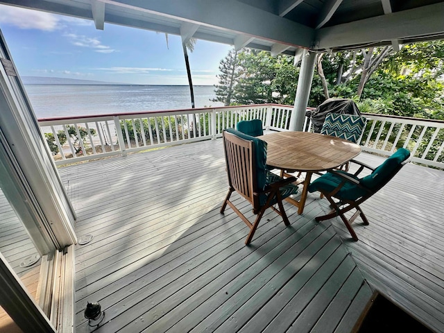 deck with a beach view and a water view