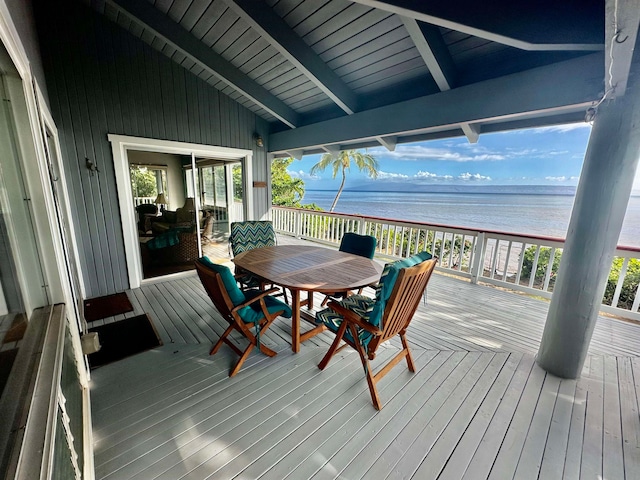 wooden deck with a water view and a beach view