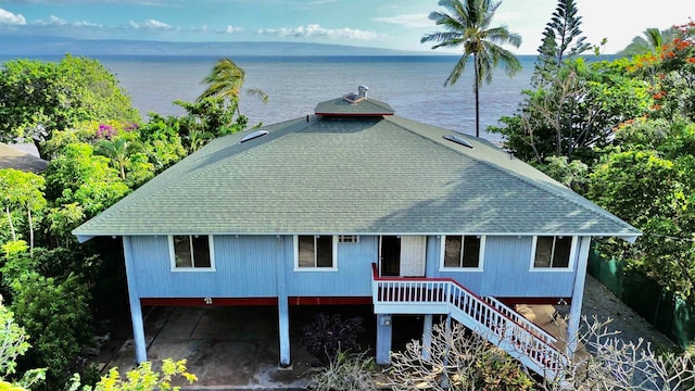 rear view of property with a water and mountain view