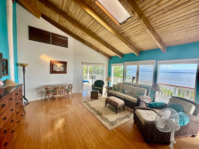 living room featuring a water view, wooden ceiling, light wood-type flooring, and beamed ceiling