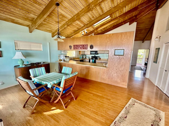 dining space featuring beamed ceiling, hardwood / wood-style flooring, sink, and wood ceiling