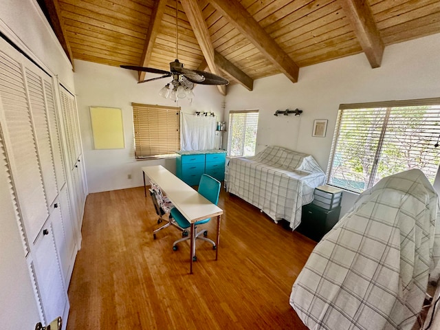 unfurnished bedroom featuring hardwood / wood-style flooring, wooden ceiling, ceiling fan, and lofted ceiling with beams