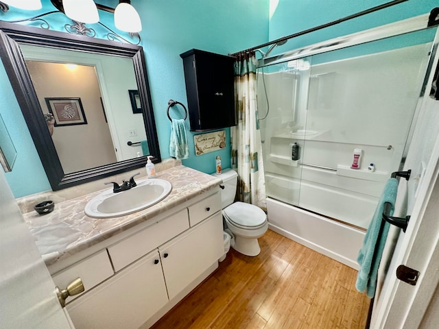 full bathroom featuring hardwood / wood-style flooring, vanity, toilet, and shower / bath combo with shower curtain