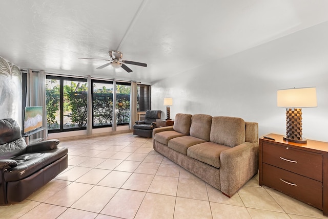 living room with light tile patterned flooring, expansive windows, and ceiling fan