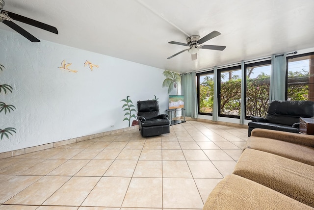 tiled living room featuring a wall of windows and ceiling fan