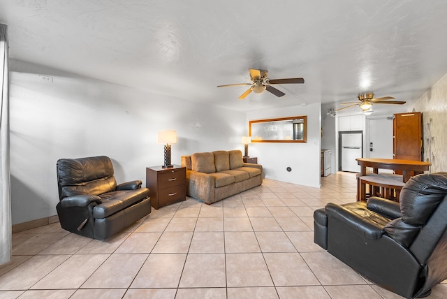 living room with ceiling fan and light tile patterned flooring