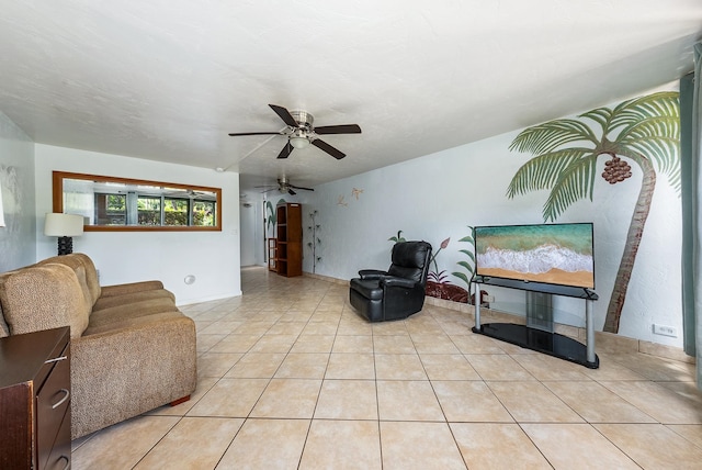 living room with a textured ceiling, ceiling fan, and light tile patterned flooring