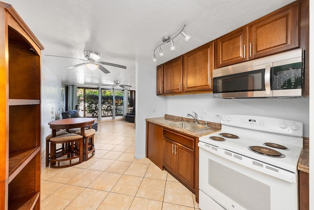 kitchen with light tile patterned floors, ceiling fan, electric range, and sink