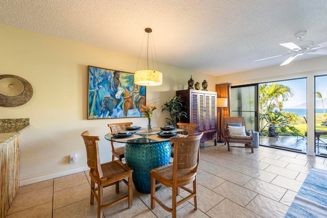 dining space with light tile patterned floors, a textured ceiling, radiator heating unit, and ceiling fan