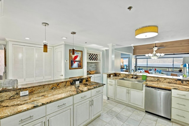 kitchen with dishwasher, sink, light stone counters, crown molding, and decorative light fixtures