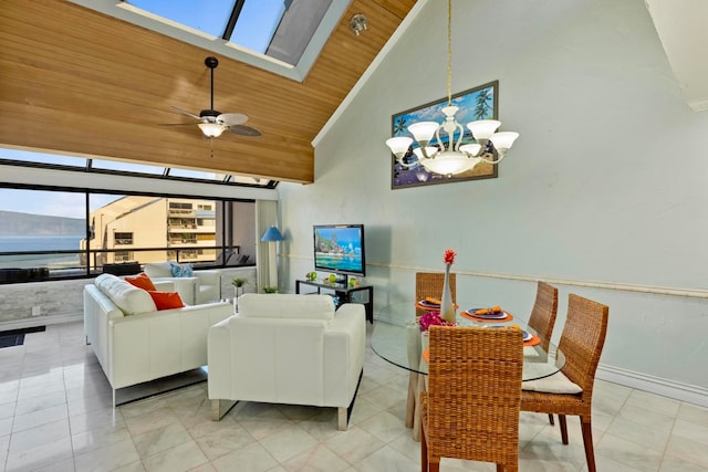 living room featuring a skylight, ceiling fan with notable chandelier, a water view, high vaulted ceiling, and wooden ceiling