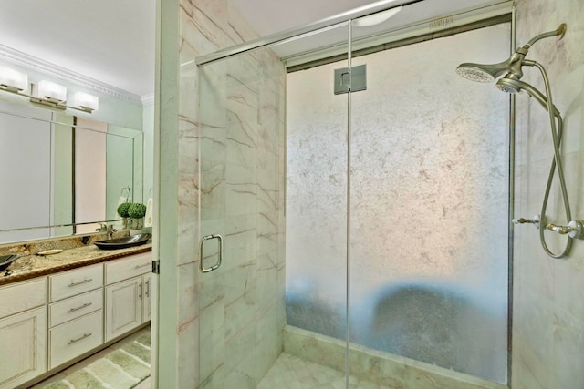 bathroom featuring vanity, an enclosed shower, and ornamental molding