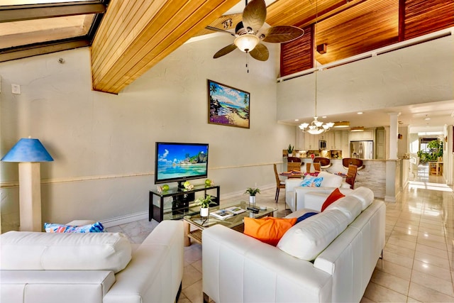 living room featuring ceiling fan with notable chandelier, light tile patterned floors, a towering ceiling, and wood ceiling