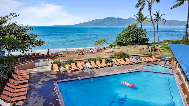 view of swimming pool with a water and mountain view