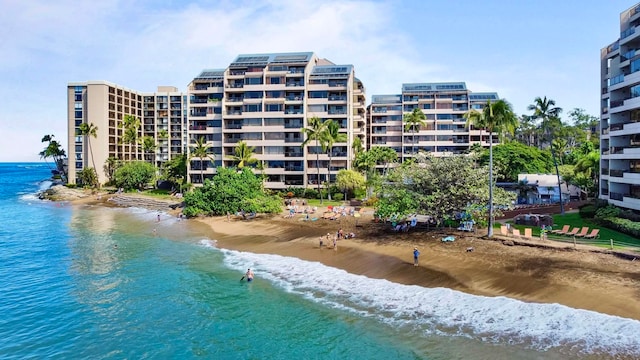 view of property featuring a water view and a beach view