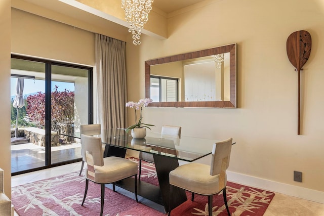 dining space with a notable chandelier and tile patterned floors