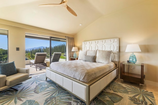 bedroom featuring access to exterior, vaulted ceiling, a mountain view, and ceiling fan