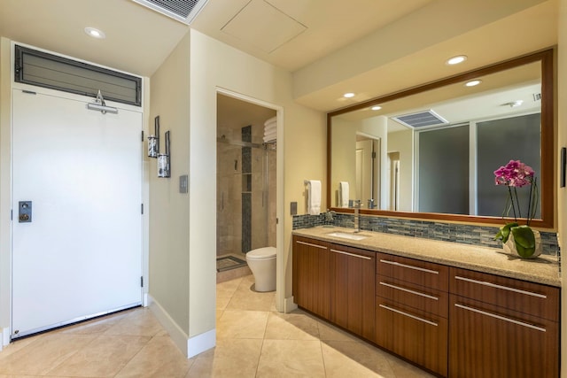 bathroom featuring vanity, decorative backsplash, tile patterned floors, and toilet