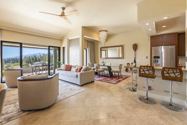 living room featuring ceiling fan, a mountain view, and light tile patterned floors