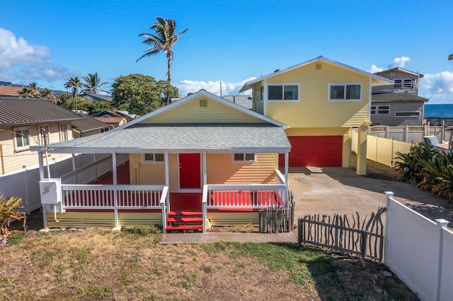 534 Kaikoo Pl, Wailuku, HI 96793 - view of front of home with a shingled roof, concrete driveway, an attached garage, and a porch