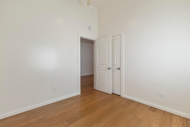 534 Kaikoo Pl, Wailuku, HI 96793 - unfurnished room with baseboards, light wood-type flooring, and a high ceiling
