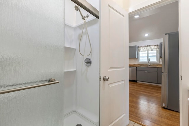 534 Kaikoo Pl, Wailuku, HI 96793 - full bathroom featuring hardwood / wood-style flooring, a stall shower, a sink, and recessed lighting